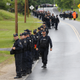 Law enforcement agents line up along a road near Cadyville, New York June 12, 2015.